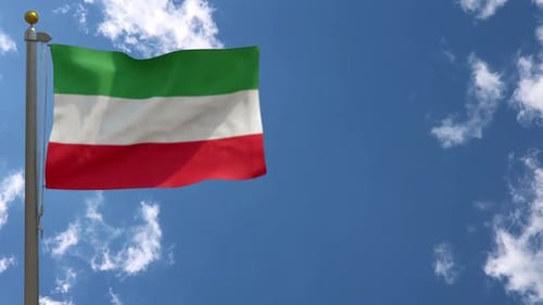 Waving Green White Red Striped Flag on Pole with Blue Sky