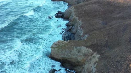 Aerial view to a beautiful wild rocky beach and big waves
