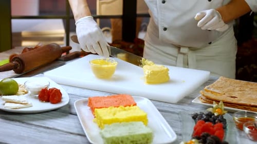 Spatula Applies Yellow Cream.