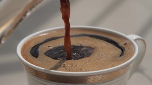 Coffee Pouring into Ceramic Mug Close-Up
