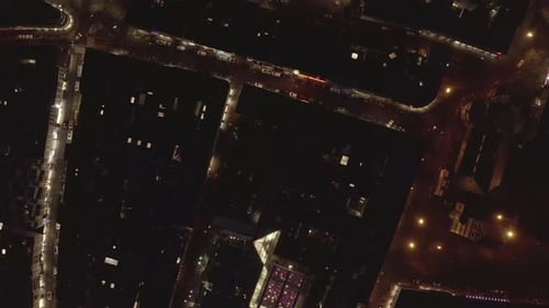 Top Down Panning Footage of Illuminated Streets Squares and Buildings in Night City