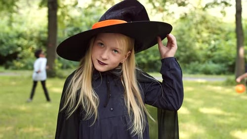 Girl Dressed as Witch Celebrates Halloween in Park