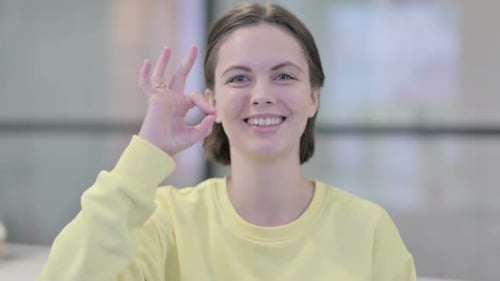 Smiling Woman Giving OK Hand Gesture
