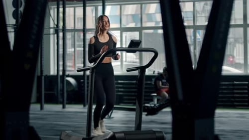 Woman Working Out on Treadmill in Gym