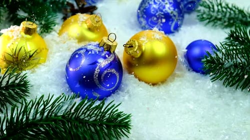 Christmas Decorations Blue and Yellow Ornaments in Snow