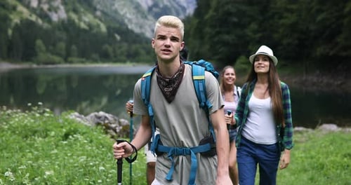 Friends Hiking Near Lake in Nature Setting