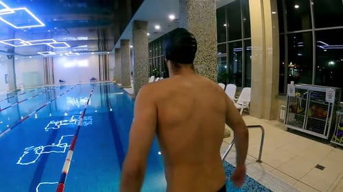 A Man in a Swimming Pool Dive in the Water and Swimming