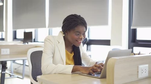 Woman Working at Computer in Modern Office