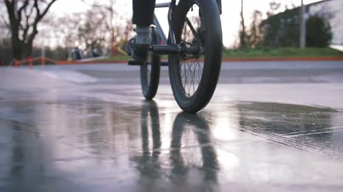 BMX Rider Doing Tricks in Street Plaza Bicycle Stunt Rider in Cocncrete Skatepark Super Slow Motion