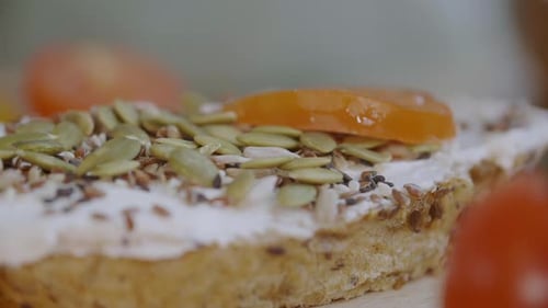 Tomato Slices added to Seeded Cream Cheese Sandwich