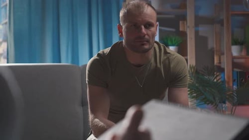Concerned Man at Therapy Session Indoors