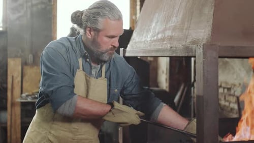 Blacksmith Working with Fire in Forge