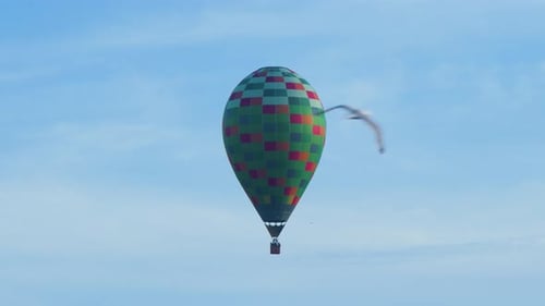 Vibrant Hot Air Balloon Drifting Through Blue Sky