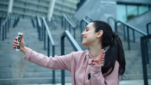 Happy Young Adult Woman Taking Smartphone Selfies