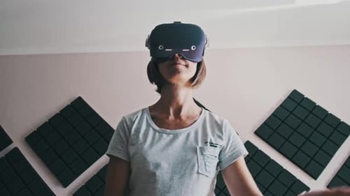 Woman Using Virtual Reality Headset with Controllers