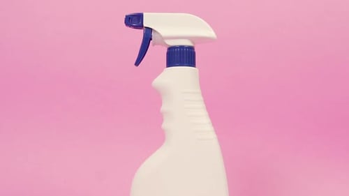 White Spray Bottle Rotating on Pink Background