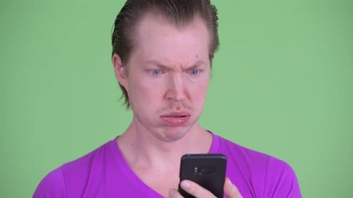 Young Man Reacting Badly to Content on Phone