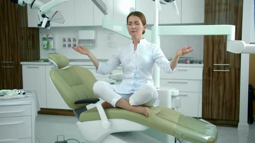 Woman Meditating in a Dental Exam Chair
