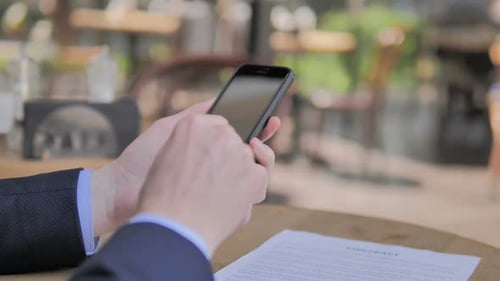 Browsing on Smartphone in Outdoor Cafe