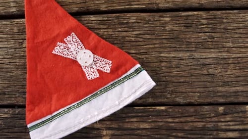 Festive Christmas Santa Hat Resting on Rustic Wood