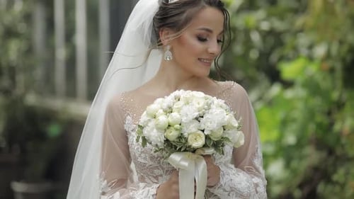 Wedding Bouquet in the Hands of Pretty Bride in the Park. Wedding Day. Engagement. Slow Motion