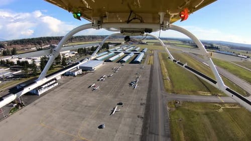 Helicopter Flying Over Airport Hangars Runway Underneath Arrival Concept