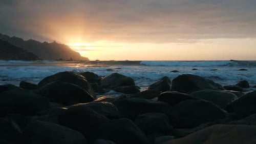 Slow Motion. Ocean Waves in Beautiful Sunset Light on Benijo Beach in Tenerife, Canary Islands
