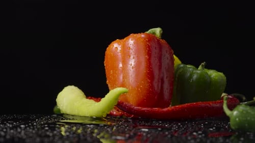 Fresh Peppers With Droplets on a Black Background