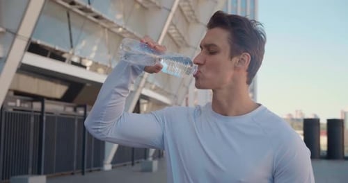 Man Drinking Water After Workout in City