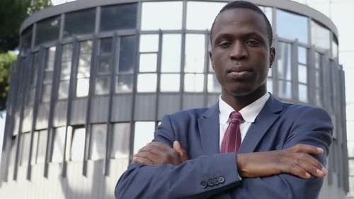 Professional Business man with crossed arms looking camera- outdoor