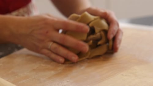 Using rolling pin to roll cookie dough