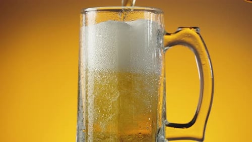 Beer Being Poured into a Glass Mug