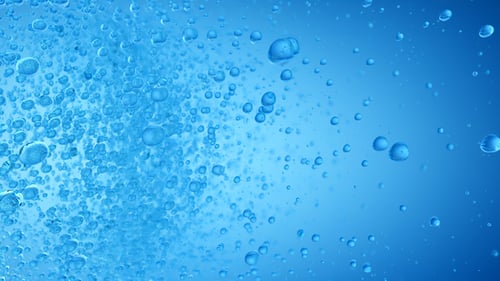 Dynamic Blue Bubbles Rising in Clear Water