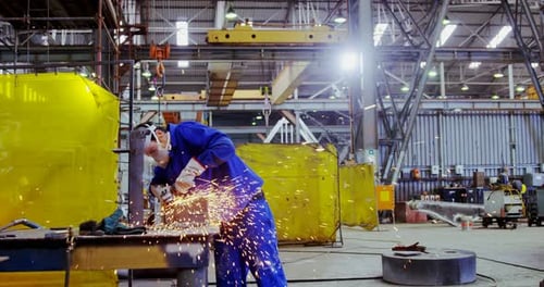Male Engineer Using Grinder Machine