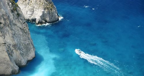 Tourist Pleasure Boats on Island Hopping Trip in Blue Sea Water Between White Cliff Rocks