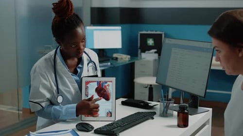Doctor Explains Heart Anatomy to Patient in Office