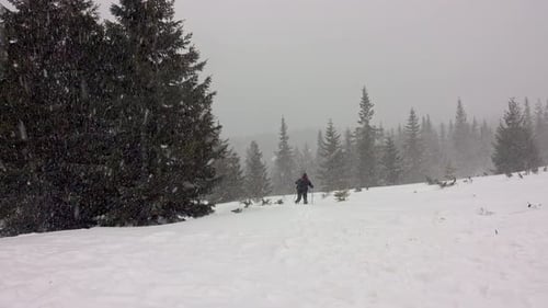 Hiker Trekking Through a Wintery Snowscape
