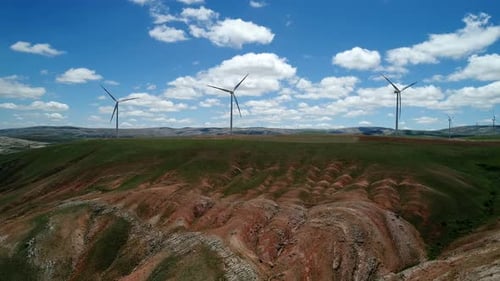 Wind Turbines Spinning on Rural Hillside, Aerial Shot