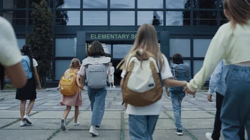Niños diversos van a la escuela con mochilas