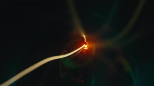 Neon Lights Circling Glowing Orb in Dark Space