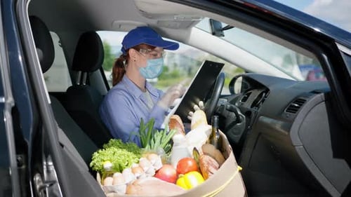 Grocery Delivery Woman Checking Order in Car
