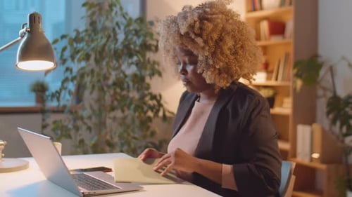 African American Businesswoman Working Late in Office