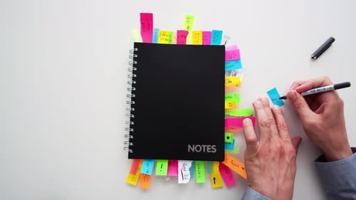 Timelapse of a businessman putting post it notes in to a notepad
