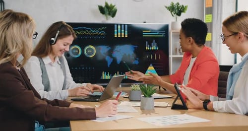 Businesswomen Reviewing Data in Office Meeting
