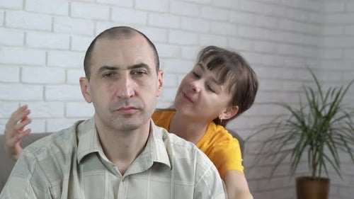Loving Daughter Hugs her Father at Home