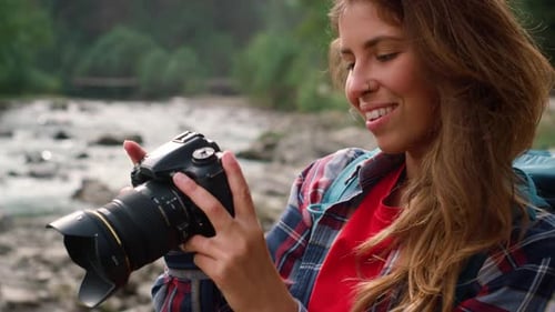Young Woman Looks at Camera in Forest River