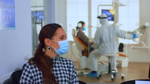Woman Waiting at the Dentist Wearing a Face Mask