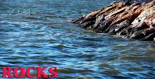 Waves Crashing on Rocky Shoreline with Seagulls