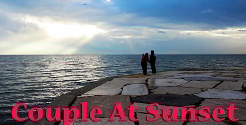 People Walking by Ocean at Sunset