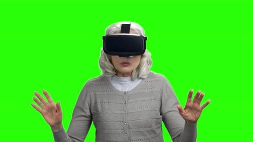 Senior Woman Wearing VR Headset on Green Screen